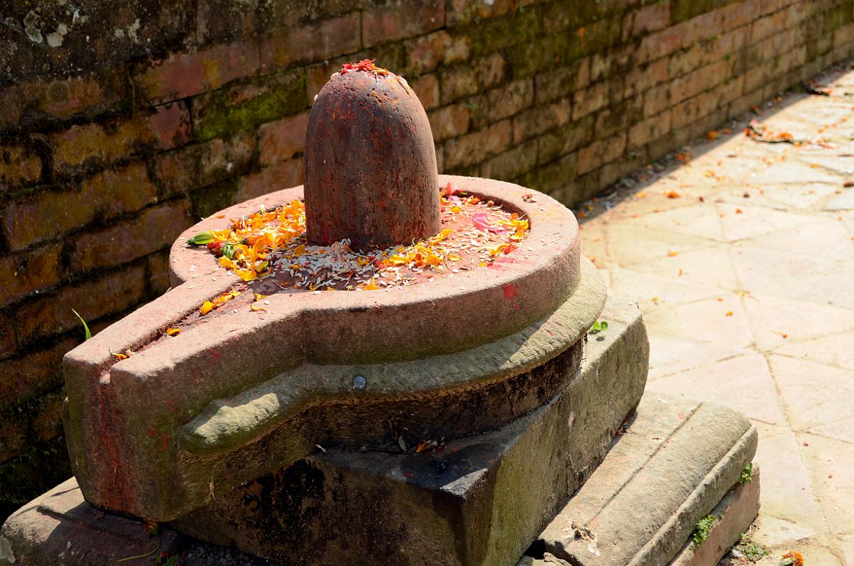 Kathmandu Changu Narayan 33 Shiva Lingam On Ground Next To Parijat Tree Platform On North East Side Of Changu Narayan Another Shiva lingam is on the ground to the right of the entrance to the Changu Narayan Temple next to the parijat tree platform.